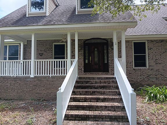 Front porch with mahogany door.