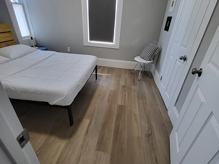 Secondary bedroom has a full size bed, bedside lighting, and a large closet.
