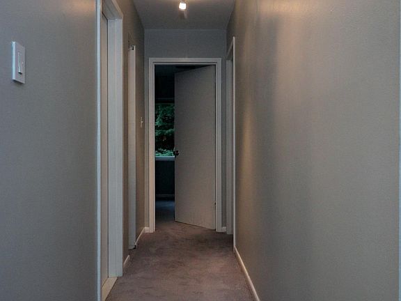 This is a view looking down the hallway, 1st door on left is spare bathroom, second is a hall closet, straight-on is the spare bedroom and to the right is the master bedroom