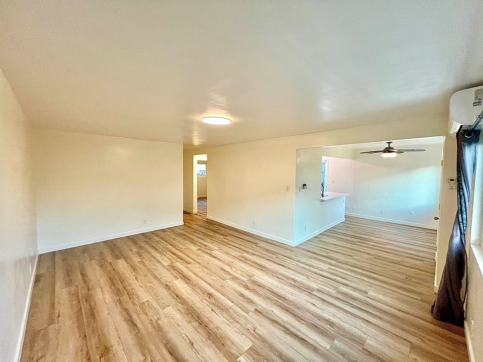 Living room with new AC with strategic positioning to cool down entire unit quickly