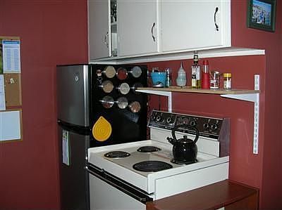 The cheerful kitchen is compact for food prep, yet has space enough for a table for dining. The 'fri