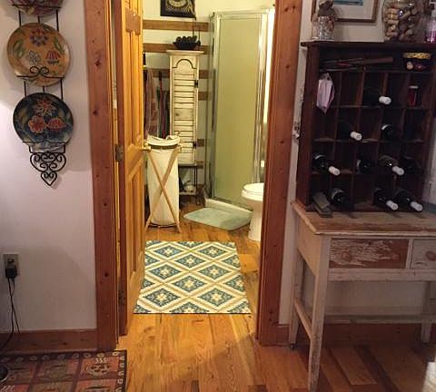 looking into downstairs bathroom and laundry room from kitchen