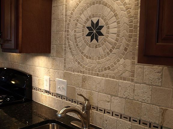 Tumbled marble backsplash gives this kitchen lots of style.