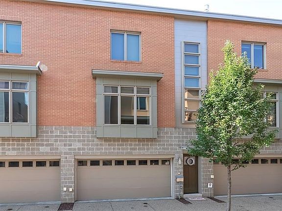 The unit's entry is marked by the wreath on the front door. The large 2-car garage is to the left of the entrance. This is a one