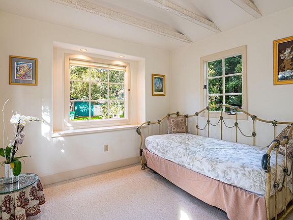 Upstairs bedroom with 2 twin beds. Carpeting has been changed to hardwood.