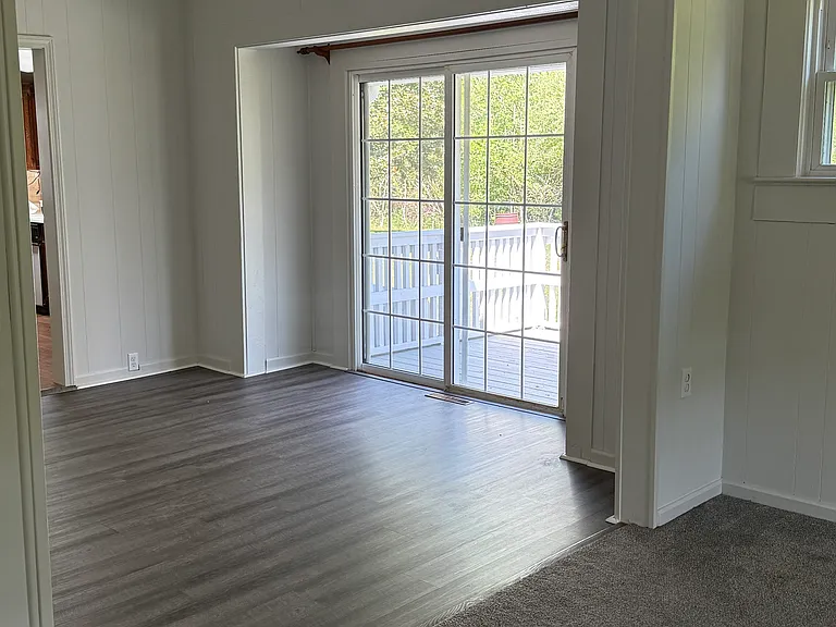 Dining room or additional sitting area with sliding glass doors leading to side deck