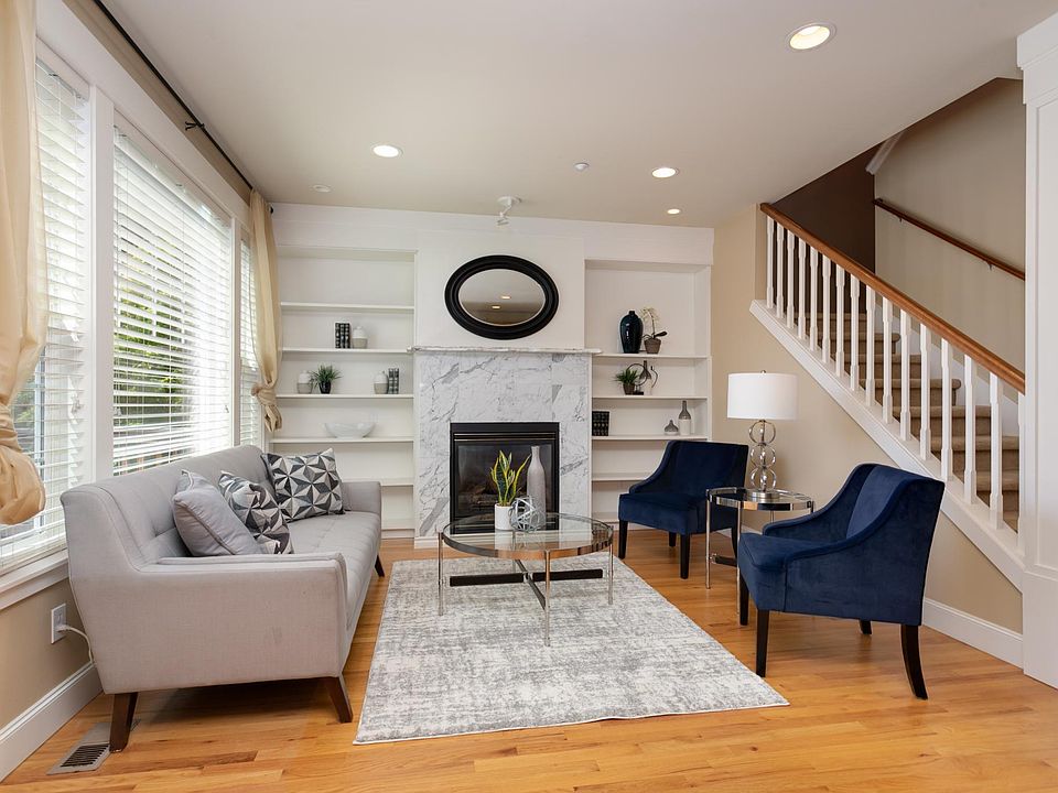 Open family room with gas fireplace and built-in shelving.