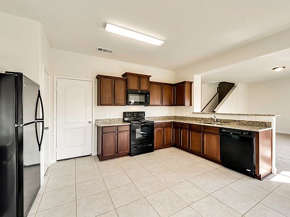Spacious kitchen comes equipped with energy efficient appliances and gorgeous granite countertops