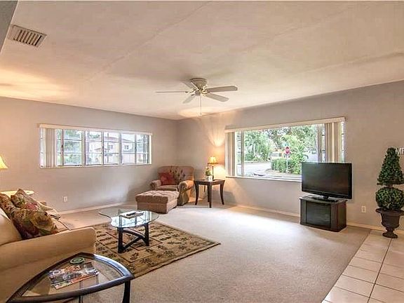 Large living room with gorgeous cove ceilings.