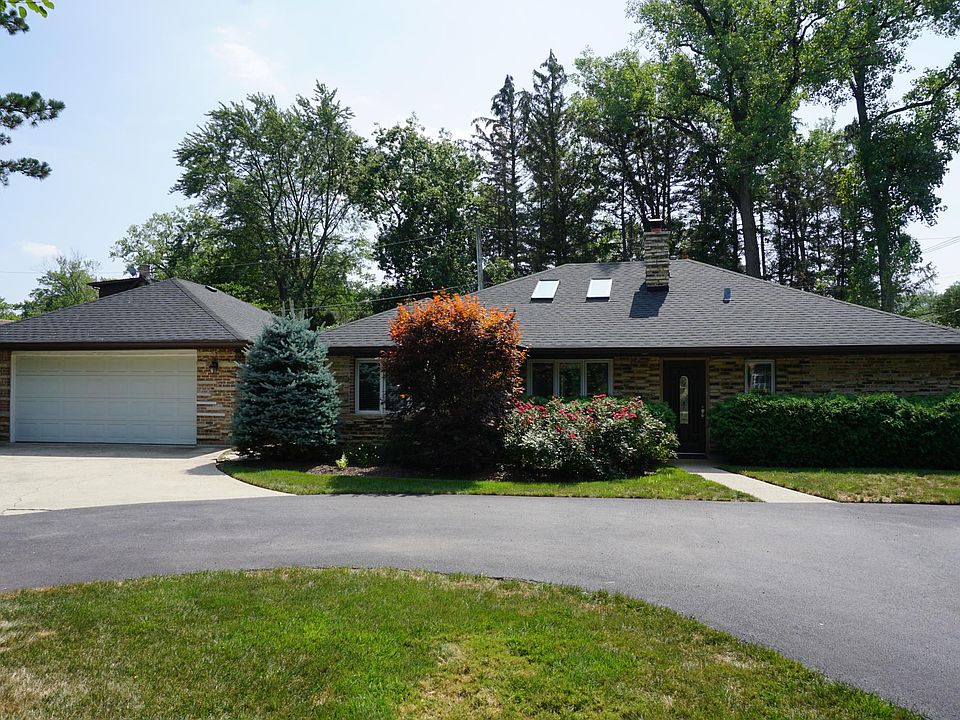 Front of the home, sitting back from a circle driveway with plenty of parking.