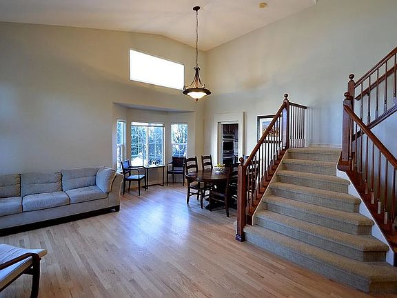 Entering this lovely home you will be greeted with soaring ceilings & a formal living & dining area create an elegant, open ambiance_perfect for entertaining or enjoying a spacious, airy feel every day.