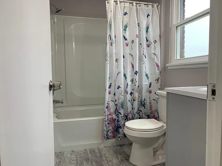Full bathroom with new tub/shower and toilet. Bathroom has exhaust fan and heat fan.