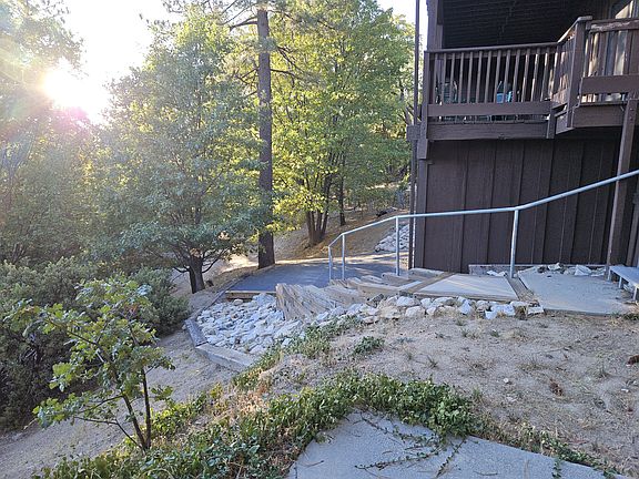 Driveway and parking pad, with street access (SW Shore Road) below.