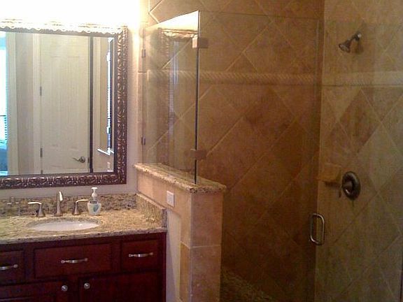 Frameless glass, travertine tile