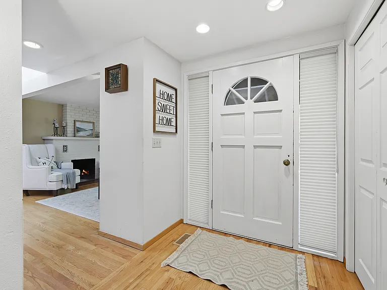 Welcoming entry with hardwood floors opening to the living room