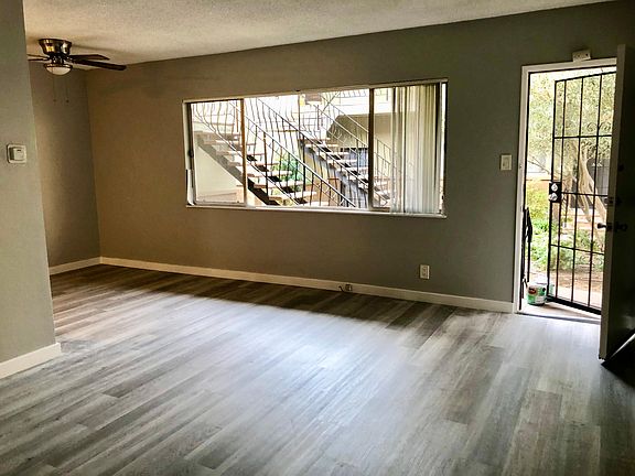 View of dinning and living area filled with natural light from large window
