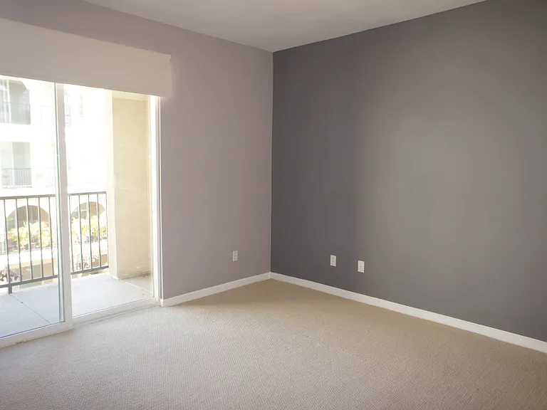 Large bedroom with the sliding door to a terrace overlooking the courtyard