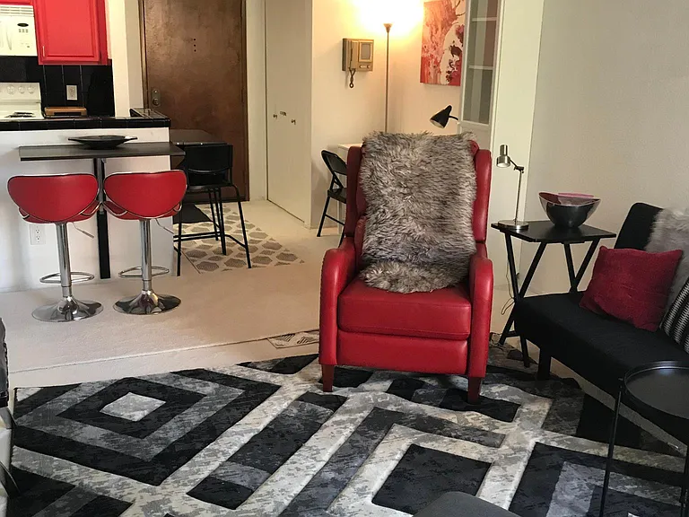 Another pic of living room view towards kitchen and front door. That red leather recliner feels like butter!