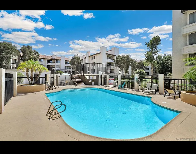 Heated pool with lounge chairs and tables