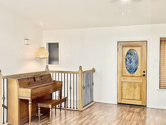 Front door, main living area of the home, kitchen is behind the camera.
