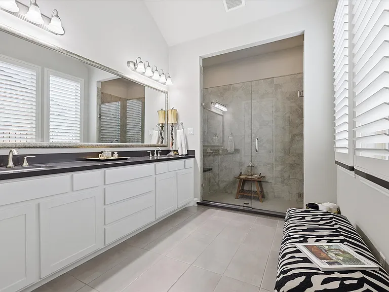 Indulge in luxury within this beautifully appointed primary bathroom, designed to provide a serene, spa-quality escape