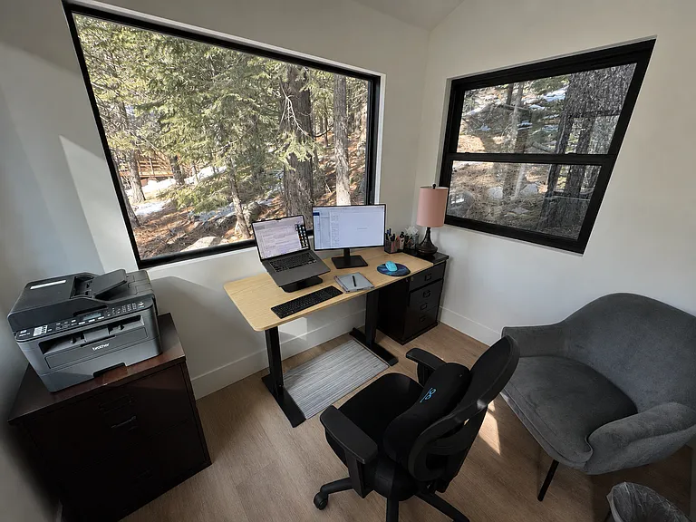 Detached flex space with large windows overlooking the forest