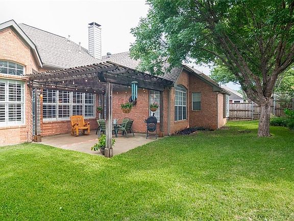 Covered patio for your casual entertaining with lots of shade from the mature tree.