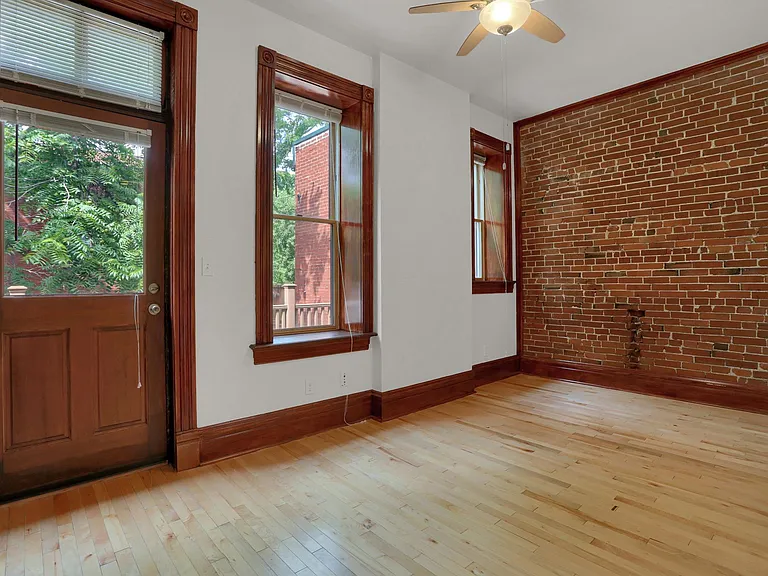 Bedroom Main Floor - exposed brick wall, hardwood floor, ceiling fan, 10' ceilings, energy-efficient lighting