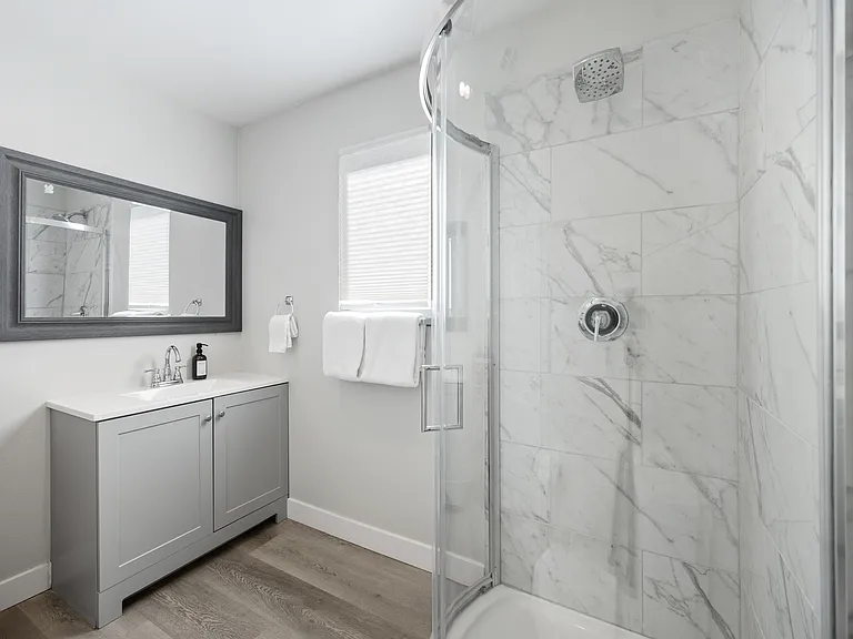 Full Bathroom 3 is located upstairs right next to Bedroom 4 and features a step-in shower with vanity sink and toilet.