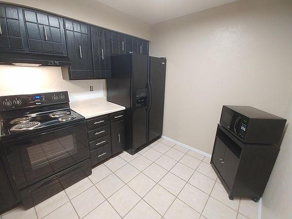 Kitchen view with microwave cart and new microwave.