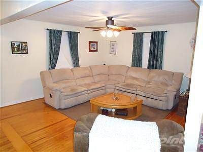 Living Room w. Upgraded Ceiling Fan, Beautiful Hardwoods and Fresh Paint! Lots of Natural Woodwork i