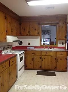 Kitchen
						:
						Kitchen overlooks sun room. Facing the back of the house,
