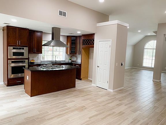 Separate view of open kitchen to family and multi-functional living space.