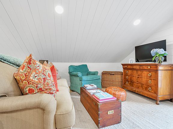 Second living room in lofted bedroom with sleeper sofa.