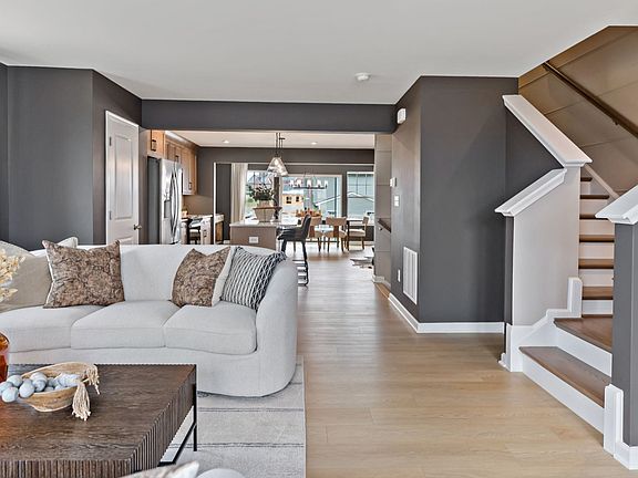 Spacious living room in a York II South Brook Townhome by DRB Homes, featuring modern decor and open