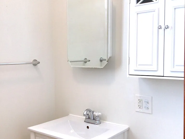 Completely rebuilt bath includes modern fixtures with a period look.