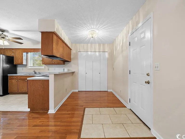 Living Room with view of Kitchen with Laundry Area