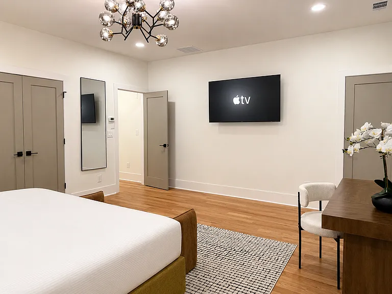 The Edgewood Suite is spacious primary king room with smart TV, blackout curtains, bedside charging, private work station, designer decor, 2 closets & plush bedding offering a self-contained escape & elevated night's sleep.