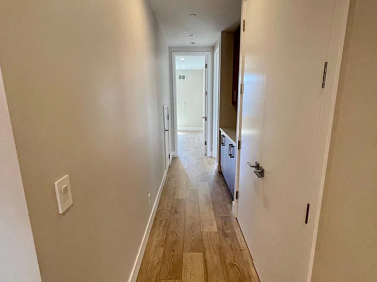 Hall, laundry closet on right, linen / drop zone ahead