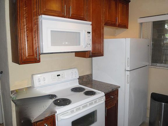 Kitchen pic 2( stove, over the range microwave and fridge)