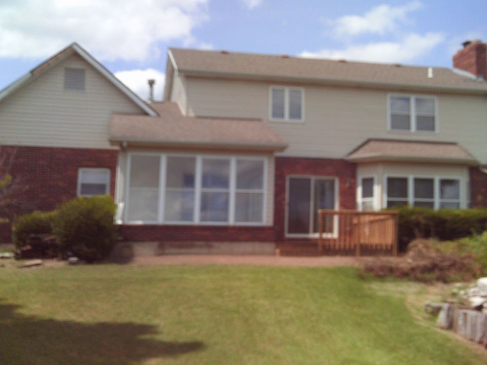 Rear view featuring sunroom