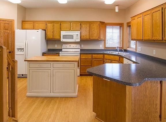 The kitchen has lots of great cupboard storage, in addition to a walk-in pantry (door on far left side)