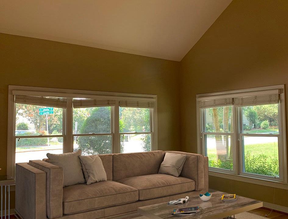 BIG family room with fantastic natural light, wood floors, volume ceilings & a fireplace.