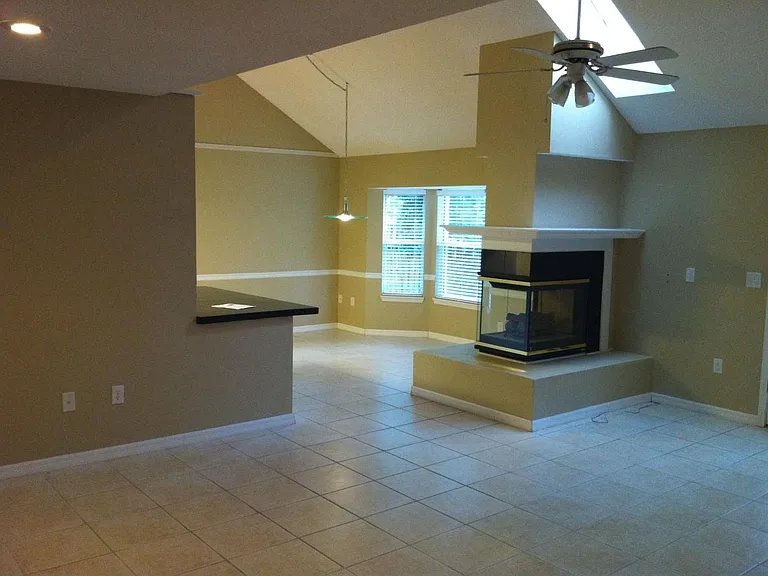 Open living room looking into kitchen and dining area