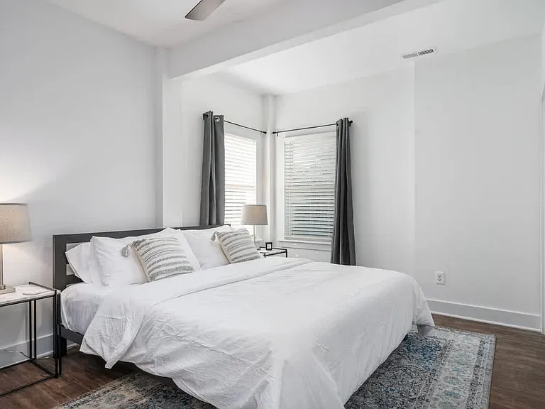 King Bedroom with side tables and dresser and full closet.