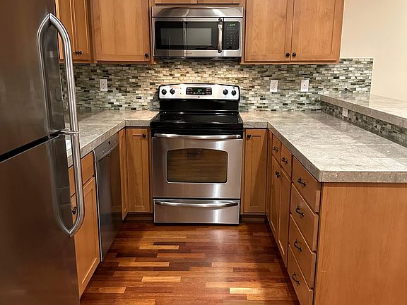 Beautiful stone countertops, serving buffet, stainless appliances and bosch dishwasher.