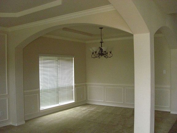 Family den with beautiful trey ceilings.