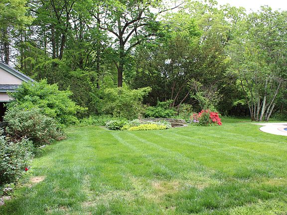 Pond with slight view of two car garage