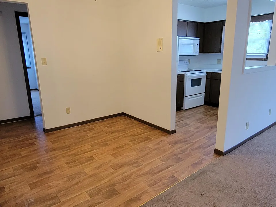 Another view of the dining area and kitchen