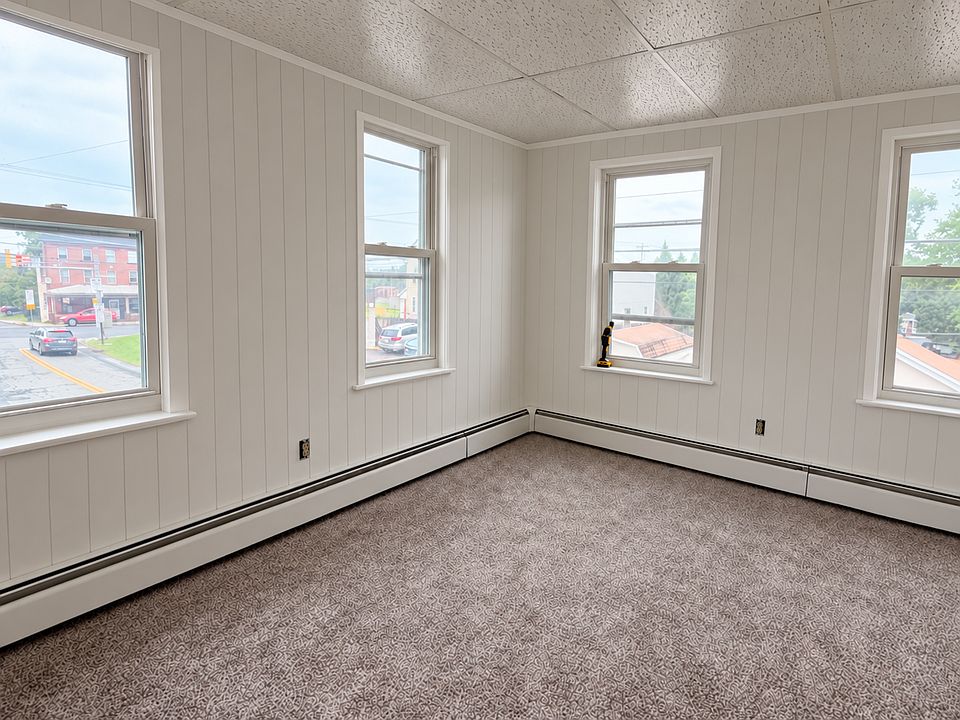 Freshly painted and new flooring throughout, pictured is living room.